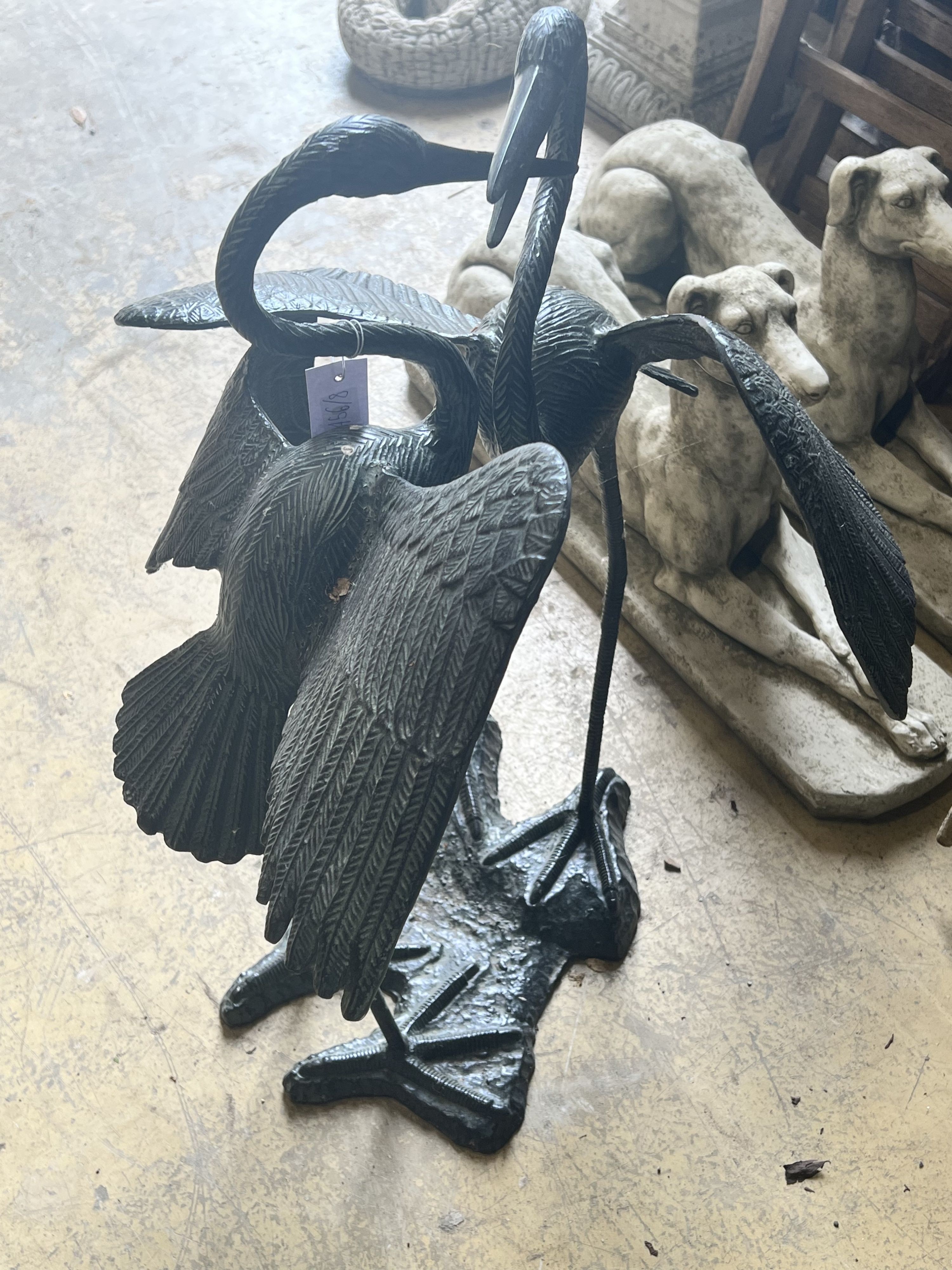 An aluminium bronze effect pair of dancing cranes, height 77cm